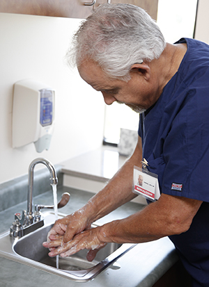 Healthcare provider washing hands.